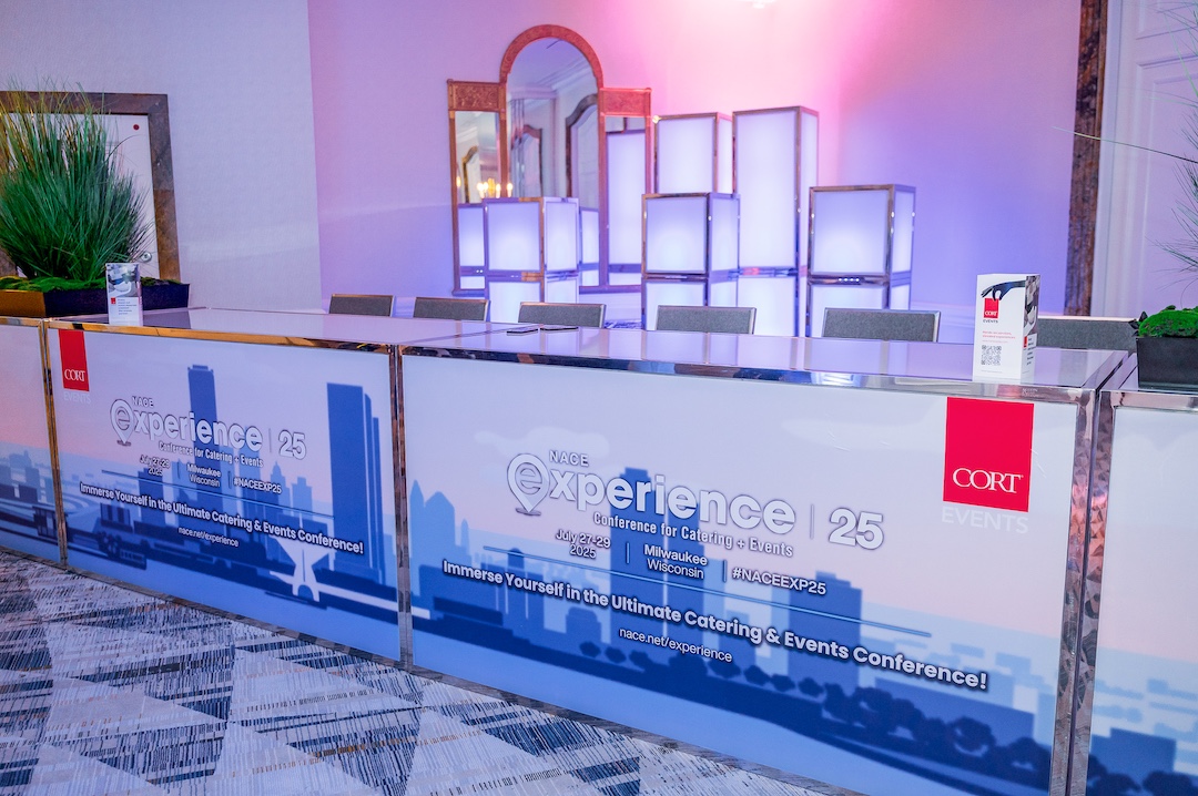 branded lit up registration desk with light up column lamps behind it
