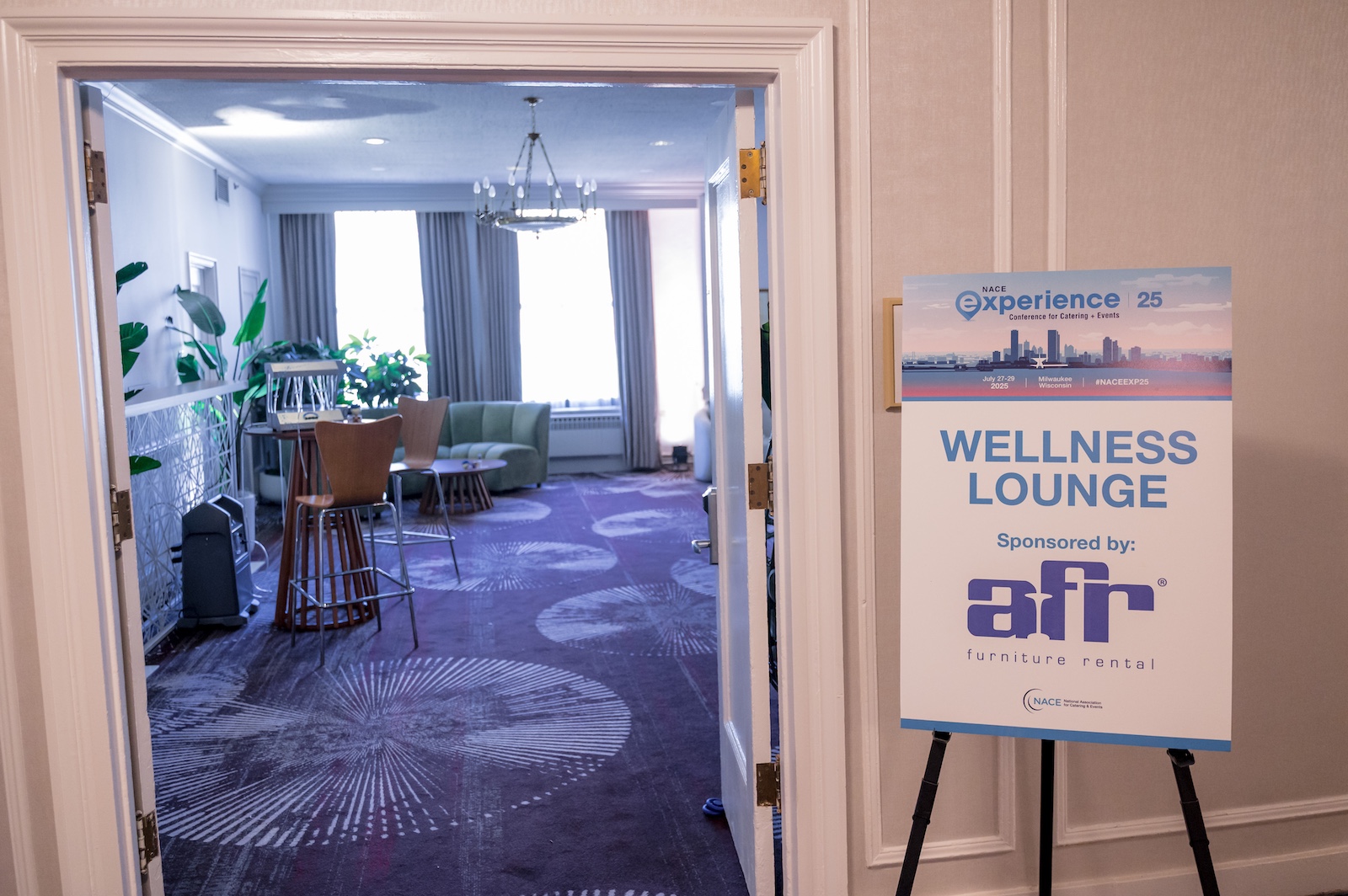 Wellness Lounge sign outside of open doors to room at NACE Experience Conference